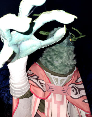 Waist-up photo of Ragsy's Owlk cosplay, reaching toward the camera.