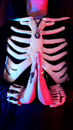 Up close photo of the rib cage breastplate and jewelry from Ragsy's Harrow the Ninth cosplay.